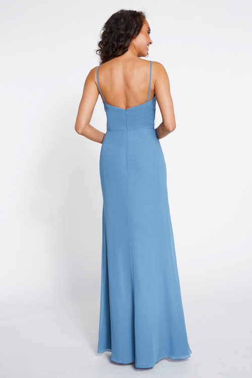 Back view of cascading draped bodice and pleated skirt with slit